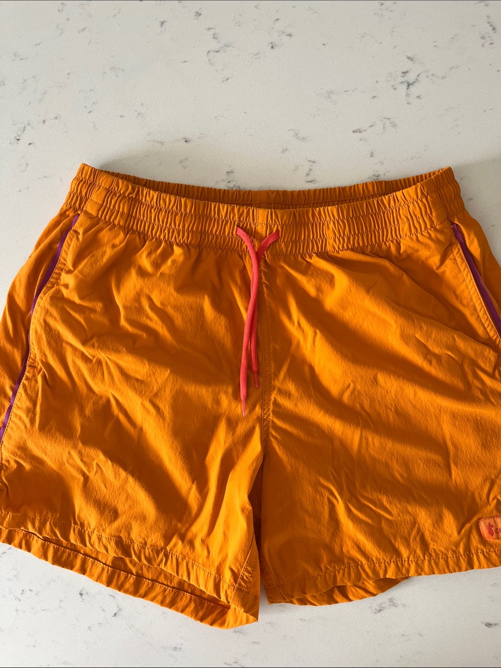 Cotopaxi Orange Swim Drawcord Shorts with Purple Accents
